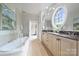 Bright bathroom with large tub, double sinks, and a glass enclosed shower at 4020 Barclay Downs Dr, Charlotte, NC 28209