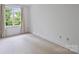 Light-filled bedroom with neutral carpet and large window at 4020 Barclay Downs Dr, Charlotte, NC 28209