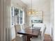 Bright dining nook showcasing a wood table, chandelier, and window with natural light at 4020 Barclay Downs Dr, Charlotte, NC 28209