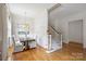 Dining area with chandelier, hardwood floors, and staircase leading to another floor at 4020 Barclay Downs Dr, Charlotte, NC 28209