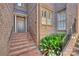 Welcoming brick entryway with steps leading to the front door and lush greenery at 4020 Barclay Downs Dr, Charlotte, NC 28209