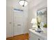 Bright foyer featuring a white door, hardwood floors, and elegant decor at 4020 Barclay Downs Dr, Charlotte, NC 28209