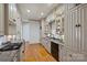 Kitchen featuring sleek grey cabinets, stainless steel appliances, and hardwood flooring at 4020 Barclay Downs Dr, Charlotte, NC 28209