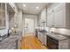 Kitchen featuring sleek grey cabinets, stainless steel appliances, and hardwood flooring at 4020 Barclay Downs Dr, Charlotte, NC 28209