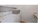 Laundry room features a front-load washer and dryer with top cabinets for added storage at 4020 Barclay Downs Dr, Charlotte, NC 28209