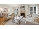 Inviting living room with fireplace, comfortable seating, and a stylish marble coffee table at 4020 Barclay Downs Dr, Charlotte, NC 28209