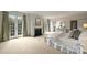 Bright main bedroom features a fireplace, french doors, and ensuite bath access at 4020 Barclay Downs Dr, Charlotte, NC 28209