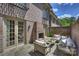 Outdoor patio with a brick fireplace, stone flooring and comfortable seating surrounded by brick walls at 4020 Barclay Downs Dr, Charlotte, NC 28209