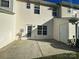 Back patio with white door, storage area, and easy access to the fenced yard at 4143 Kenton Glenn Nw Ct, Concord, NC 28027