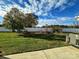 Spacious backyard with a well-maintained lawn, mature trees and white vinyl fence at 4143 Kenton Glenn Nw Ct, Concord, NC 28027