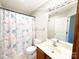 Cozy bathroom with a shower featuring a colorful, patterned curtain, and a neutral vanity at 4143 Kenton Glenn Nw Ct, Concord, NC 28027