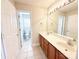 Well-lit bathroom with double sinks and access to the toilet and shower area at 4143 Kenton Glenn Nw Ct, Concord, NC 28027
