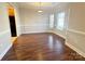 Bright dining room with wood floors, wainscoting, and natural light from large windows at 4143 Kenton Glenn Nw Ct, Concord, NC 28027