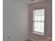 Bedroom with a window providing natural light, light walls, and electrical outlets at 428 Lexie Ln # 100, Rock Hill, SC 29732