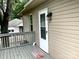 Back porch with door has railing and lighting fixture at 439 17Th St, Cramerton, NC 28032