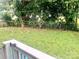 View of expansive backyard with green trees and fencing from top of wooden porch railing at 439 17Th St, Cramerton, NC 28032