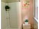 Cozy bathroom with white tiled shower, neutral paint, decorative accents and window at 439 17Th St, Cramerton, NC 28032
