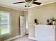 Bedroom features neutral walls, carpet, a fireplace, fan, and a door at 439 17Th St, Cramerton, NC 28032