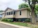 A cozy home featuring a screened-in porch and large, mature shade trees at 439 17Th St, Cramerton, NC 28032