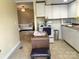 Open kitchen showcases white cabinetry, an island, and a view into the living room at 439 17Th St, Cramerton, NC 28032