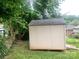 Wood storage shed in fenced backyard with green trees at 439 17Th St, Cramerton, NC 28032