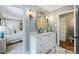 This bathroom offers marble flooring and vanity top, framed mirror, and natural light at 4501 Montibello Dr, Charlotte, NC 28226