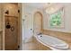 This beautifully designed bathroom features a tub, a shower and nice accents at 4501 Montibello Dr, Charlotte, NC 28226