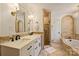 This beautiful bathroom features double sinks, framed mirrors, a shower, and a soaking tub at 4501 Montibello Dr, Charlotte, NC 28226