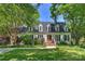 Charming home featuring a manicured lawn and brick entryway, framed by mature trees at 4501 Montibello Dr, Charlotte, NC 28226