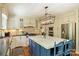 A well-lit kitchen features custom cabinetry, an island with a marble countertop, and stainless steel appliances at 4501 Montibello Dr, Charlotte, NC 28226