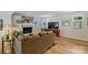 Open living room featuring hardwood floors, fireplace, TV and comfortable sofa at 4501 Montibello Dr, Charlotte, NC 28226