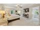Spacious main bedroom features neutral colors, a ceiling fan, and comfortable seating area at 4501 Montibello Dr, Charlotte, NC 28226