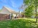 Backyard featuring a privacy fence, grassy lawn, mature trees, and a deck attached to the home at 4656 Chaucer Nw Pl, Concord, NC 28027