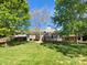 A well-maintained lawn and a spacious wooden deck offer ample space for outdoor enjoyment and entertaining at 4656 Chaucer Nw Pl, Concord, NC 28027