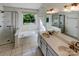 Bright bathroom with a double sink, vanity, walk-in shower, and a large soaking tub by a window at 4656 Chaucer Nw Pl, Concord, NC 28027