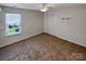 Bedroom featuring carpet, a window with blinds, and a closet with bi-fold doors at 4656 Chaucer Nw Pl, Concord, NC 28027