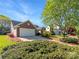 Well-maintained home with a two-car garage, lush lawn, and manicured shrubbery create inviting curb appeal at 4656 Chaucer Nw Pl, Concord, NC 28027
