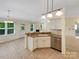 Open-concept kitchen features granite countertops, stainless steel appliances, and seamless flow to the dining and living areas at 4656 Chaucer Nw Pl, Concord, NC 28027