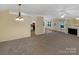 Spacious living room with ample natural light, open floor plan, fireplace, and easy access to the kitchen at 4656 Chaucer Nw Pl, Concord, NC 28027