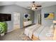 Inviting main bedroom with a ceiling fan, ensuite bathroom, and neutral decor, virtually staged for appeal at 4656 Chaucer Nw Pl, Concord, NC 28027