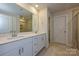 Bright bathroom featuring double sinks, stone countertops, and a glass-enclosed shower at 5017 Poplin Vly, Cherryville, NC 28021