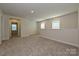 Spacious bonus room with neutral walls and carpet, brightened by natural light from windows at 5017 Poplin Vly, Cherryville, NC 28021