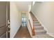 Inviting entryway showcasing hardwood floors, a staircase with wooden railing, and natural light at 5017 Poplin Vly, Cherryville, NC 28021