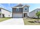 Charming two-story home featuring stone accents, neutral siding, a two-car garage, and manicured landscaping at 5017 Poplin Vly, Cherryville, NC 28021
