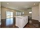 Spacious kitchen island overlooking an open layout with hardwood floors and access to outdoor living at 5017 Poplin Vly, Cherryville, NC 28021
