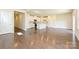 Open-concept living room with hardwood floors, seamlessly connected to the kitchen with white cabinetry at 5017 Poplin Vly, Cherryville, NC 28021