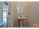 Modern powder room featuring a pedestal sink, oval mirror, and neutral wall color at 5017 Poplin Vly, Cherryville, NC 28021