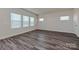 Bright bedroom with lots of light, wood-look flooring, neutral walls, and a door on the right side at 5018 Poplin Vly, Cherryville, NC 28021