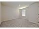 Neutral bedroom with carpeted floors, a window, and convenient electrical outlets at 5018 Poplin Vly, Cherryville, NC 28021