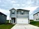 Charming two-story home features a two-car garage, beautiful landscaping, and a welcoming front entrance at 5018 Poplin Vly, Cherryville, NC 28021
